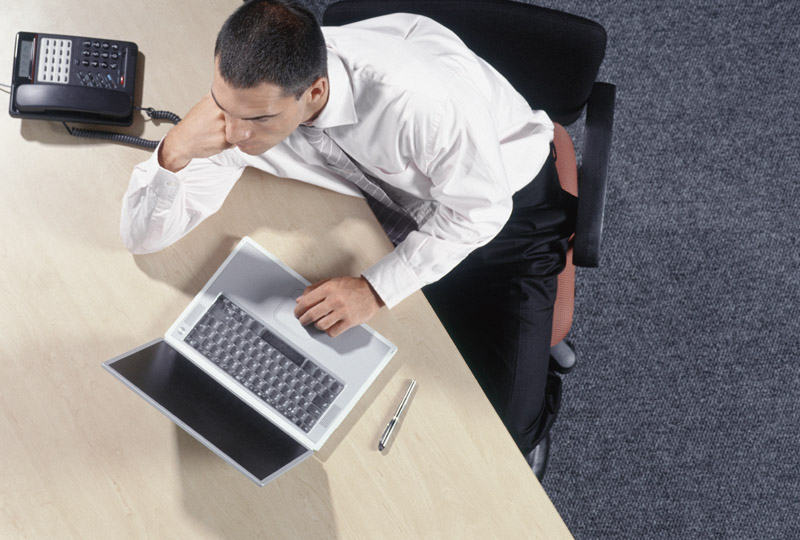 Man working at desk on laptop